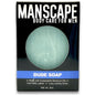 Manscape Dude Soap packaging with a green soap bar on a black background